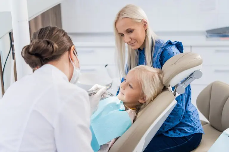 At Andros Orthodontics' how to fix overbite in Pasco, WA, a child receives overbite treatment from a dentist while an adult woman sits nearby in the clinic.