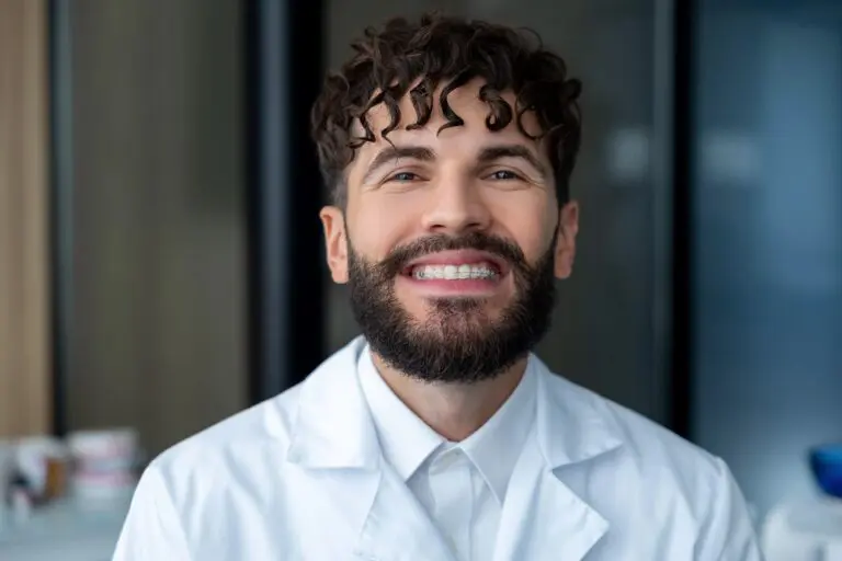 bearded man dentist clear braces showing importance dental care - How Long Do Braces Take in Pasco, WA