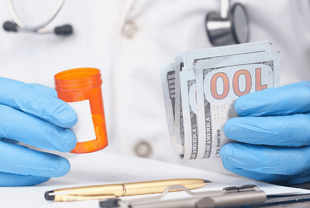 In Pasco, WA, Andros Orthodontics features an image of a person in a lab coat and blue gloves holding a pill bottle and several $100 bills, with a pen, clipboard, and Invisalign Payment Plan brochure on the table.