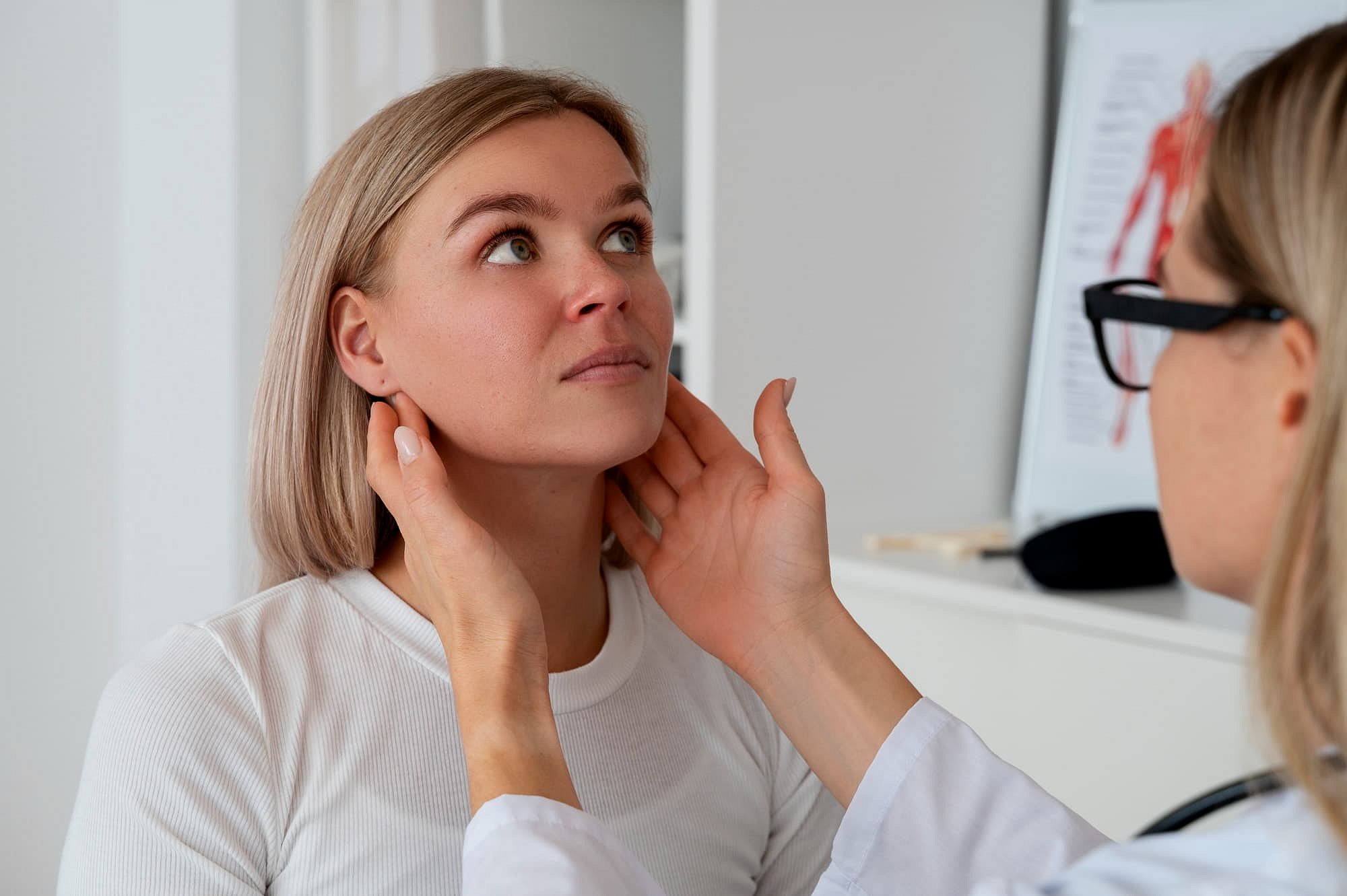 At Andros Orthodontics in Pasco, WA, a healthcare professional gently presses a patient's neck to check lymph nodes—an important step before jaw surgery.